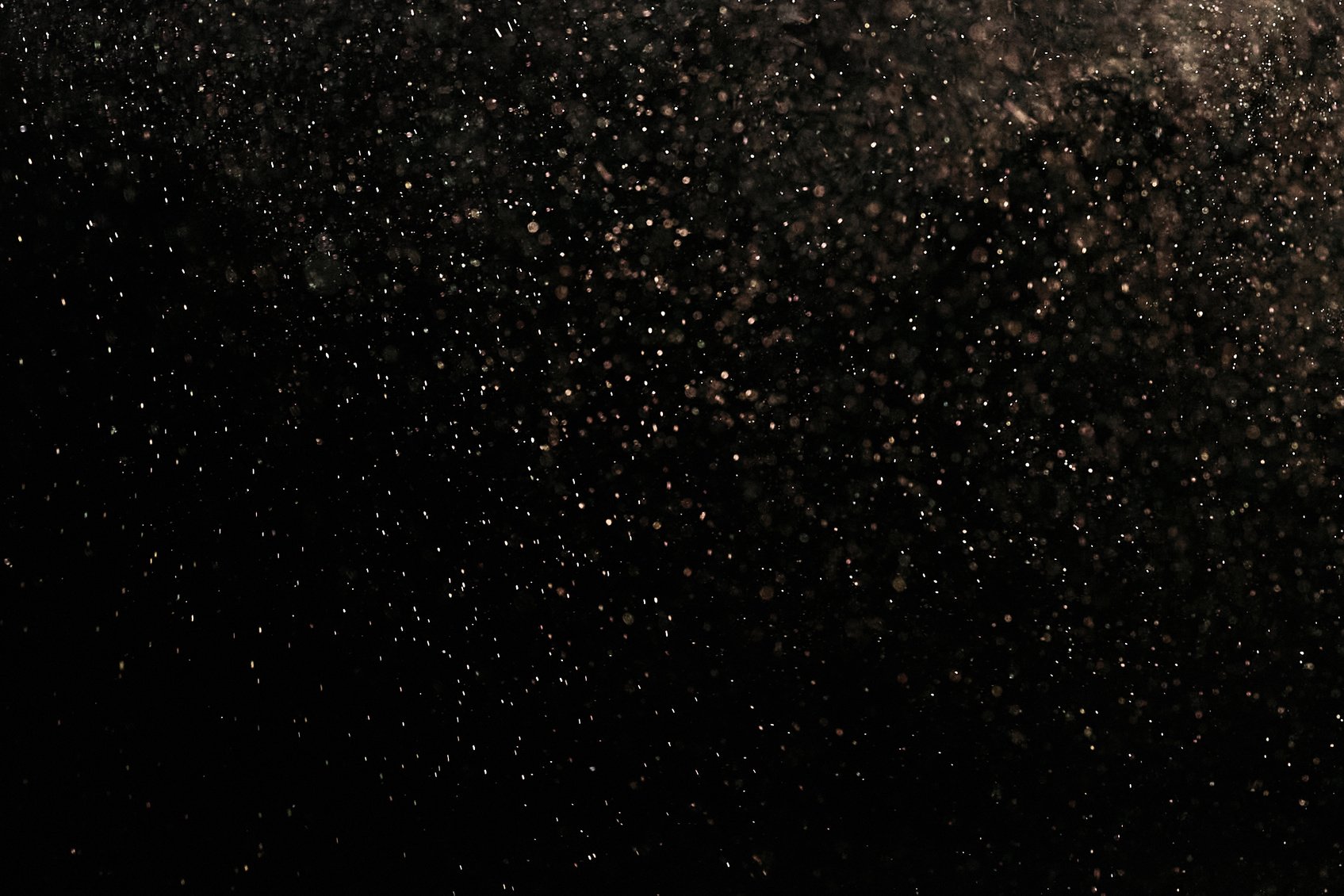 White Dust Particles on Black Background